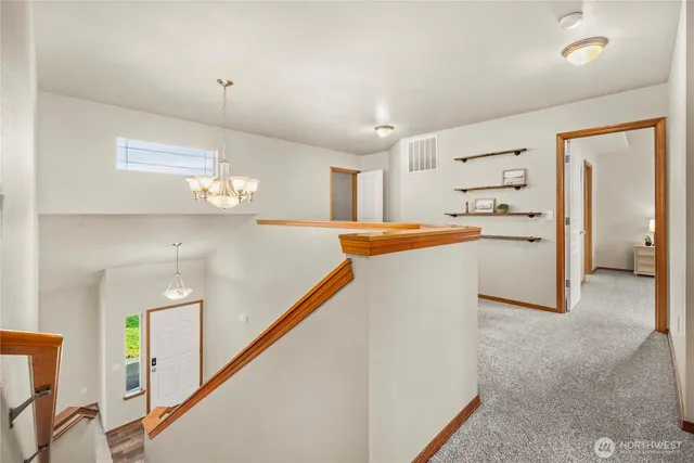 a kitchen with stainless steel appliances a refrigerator and a chandelier