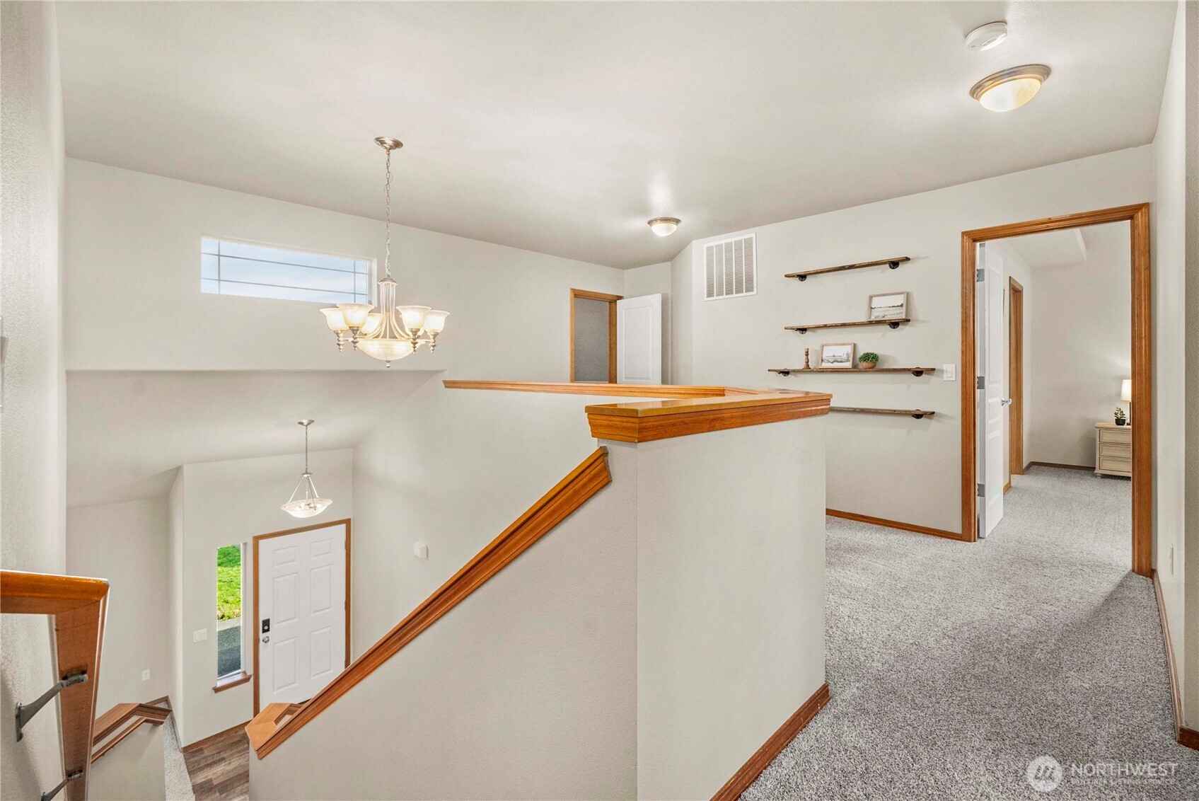 1503 Riddell Avenue Northeast Orting, WA 98360 - Photo 32 of 40 a kitchen with stainless steel appliances a refrigerator and a chandelier