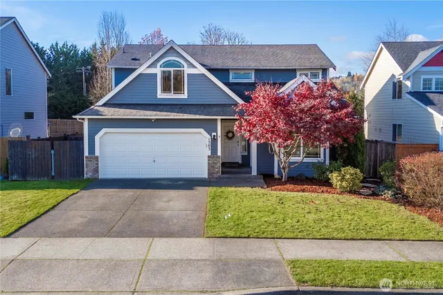 a front view of a house with a yard and garage