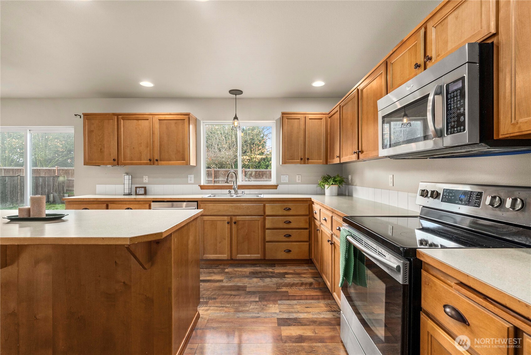 1503 Riddell Avenue Northeast Orting, WA 98360 - Photo 4 of 40 a kitchen with stainless steel appliances granite countertop a sink stove and cabinets