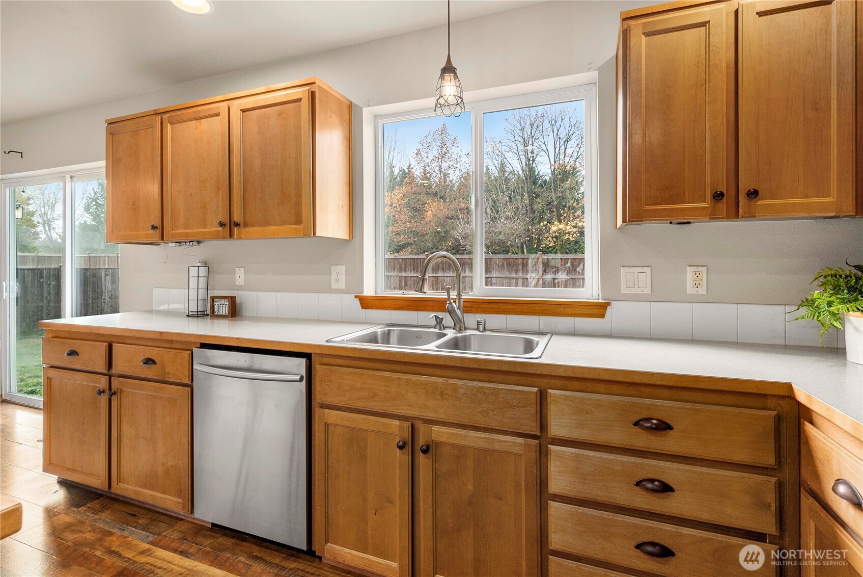 1503 Riddell Avenue Northeast Orting, WA 98360 - Photo 5 of 40 a kitchen with stainless steel appliances granite countertop white cabinets window and sink