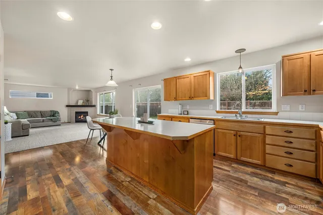 a large kitchen with kitchen island granite countertop a sink and a large window