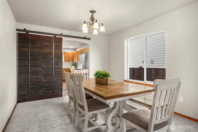 a view of a dining room with furniture and window