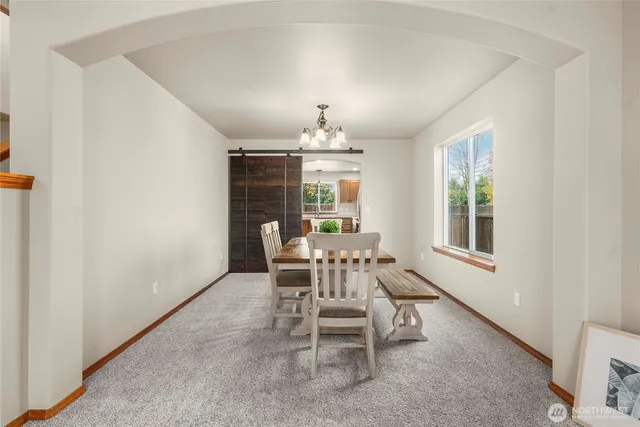 a dining room with furniture and window
