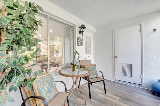 a view of a dining room with furniture window and wooden floor
