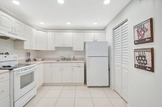 a kitchen with a white cabinets and white appliances