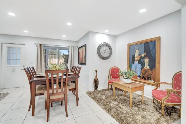 a dining room with a wooden table and chairs