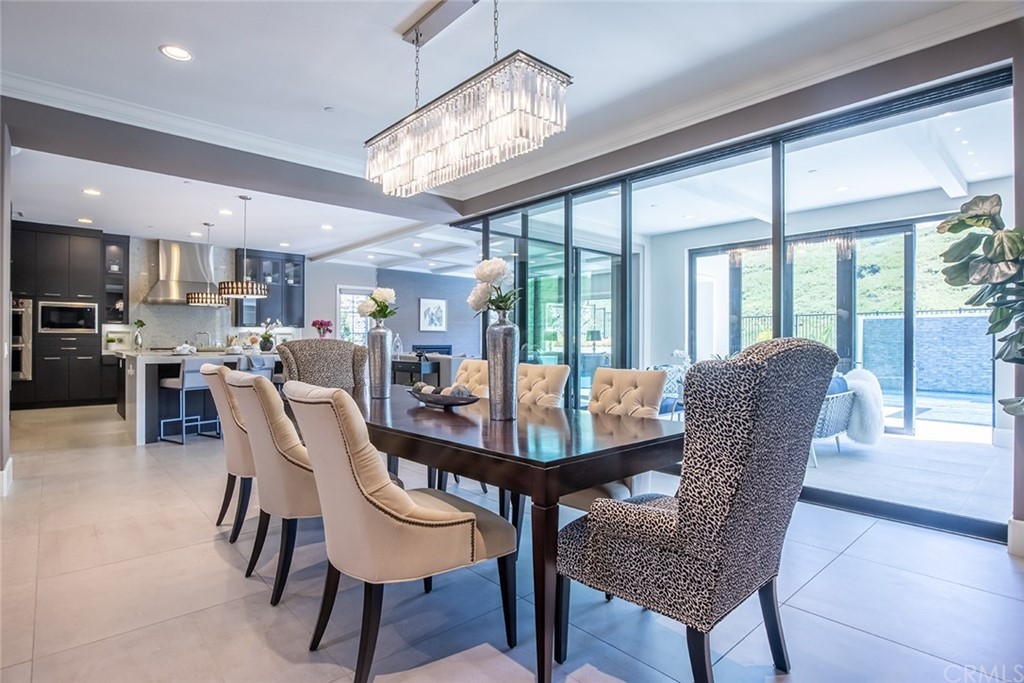 124 Panorama Irvine, CA 92618 - Photo 4 of 61 a dining room with furniture a chandelier and wooden floor