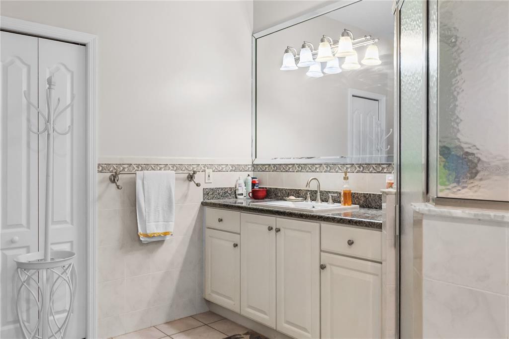 1 Elder Place Palm Coast, FL 32164 - Photo 16 of 34 a bathroom with a double vanity sink and a mirror