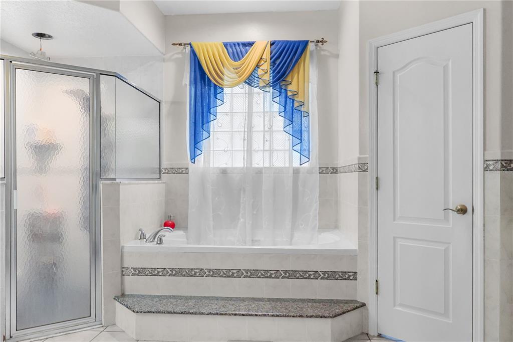 1 Elder Place Palm Coast, FL 32164 - Photo 17 of 34 a bathroom with a bathtub and shower