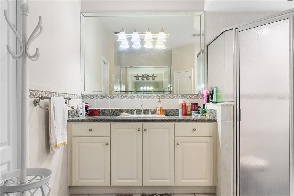 1 Elder Place Palm Coast, FL 32164 - Photo 18 of 34 a kitchen with granite countertop white cabinets and window