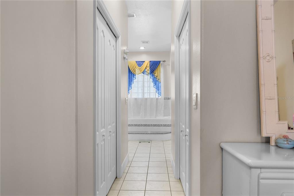 1 Elder Place Palm Coast, FL 32164 - Photo 19 of 34 a bathroom with a sink and mirror with shower