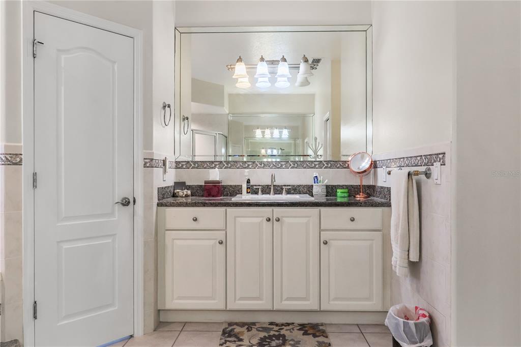 1 Elder Place Palm Coast, FL 32164 - Photo 21 of 34 a bathroom with granite countertop a sink and a window