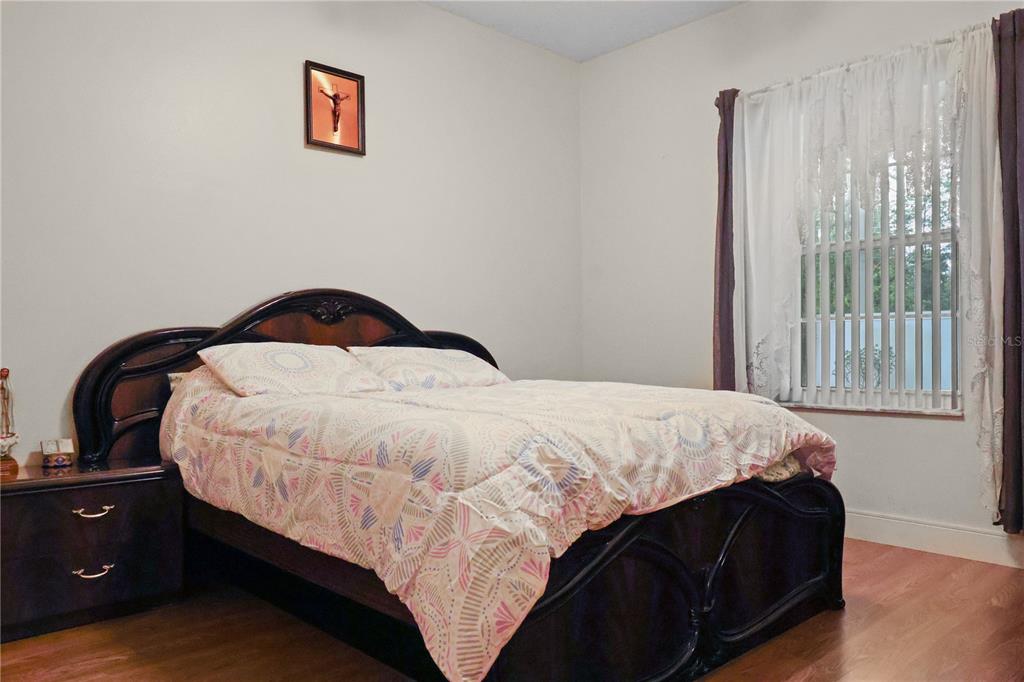1 Elder Place Palm Coast, FL 32164 - Photo 23 of 34 a bedroom with a bed and wooden floor