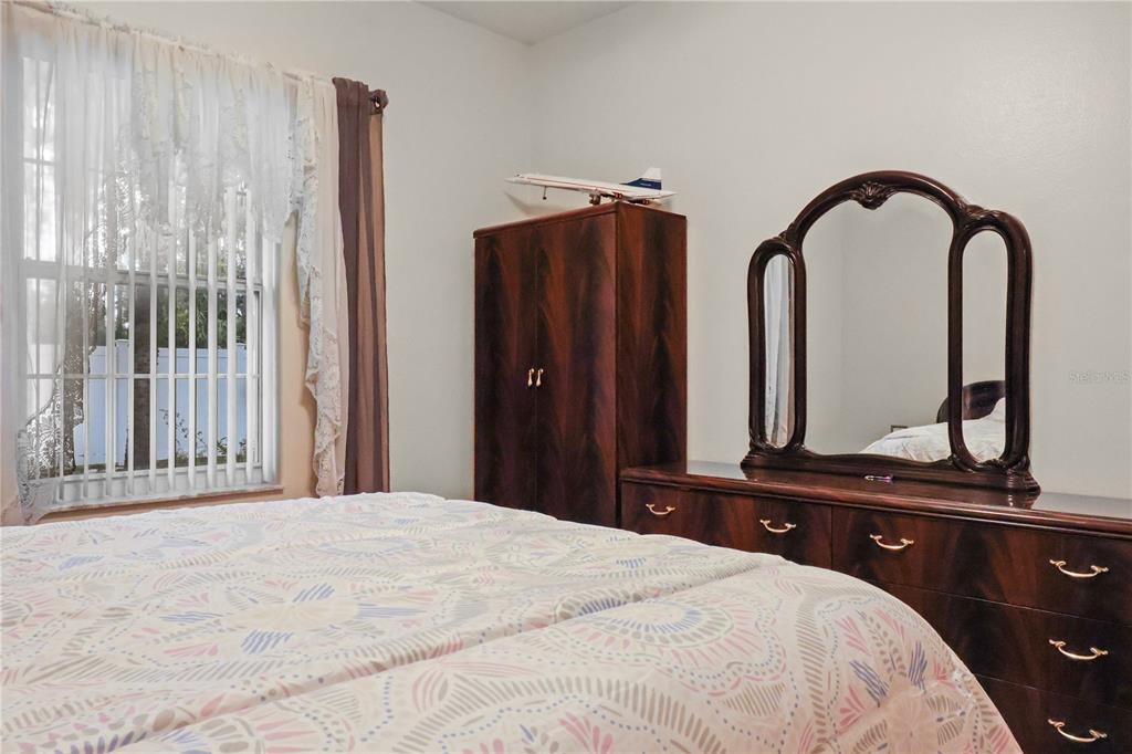 1 Elder Place Palm Coast, FL 32164 - Photo 24 of 34 a bedroom with a bed and a dresser