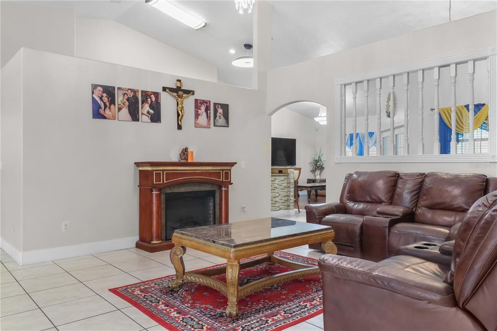 1 Elder Place Palm Coast, FL 32164 - Photo 6 of 34 a living room with furniture and a fireplace
