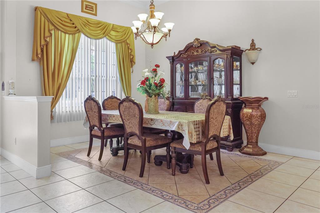 1 Elder Place Palm Coast, FL 32164 - Photo 7 of 34 a view of a dining room with furniture and chandelier