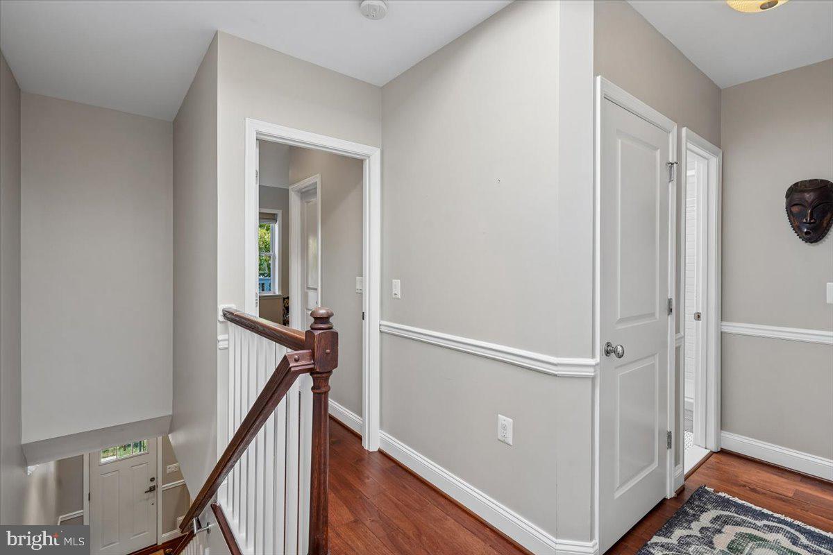 1203 Staples Street Northeast Washington, DC 20002 - Photo 22 of 51 Inviting hallway with warm wood accents & Laundry