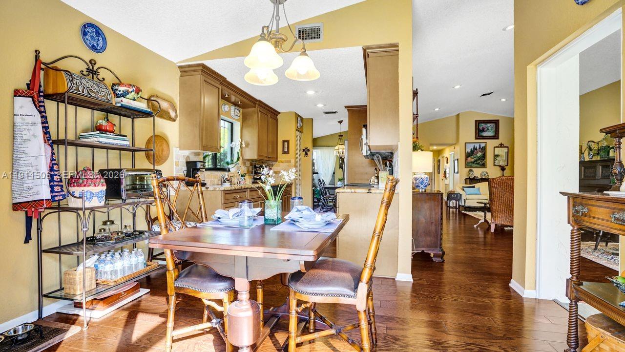 10858 White Aspen Lane Boca Raton, FL 33428 - Photo 14 of 72 a view of a dining room with furniture and wooden floor