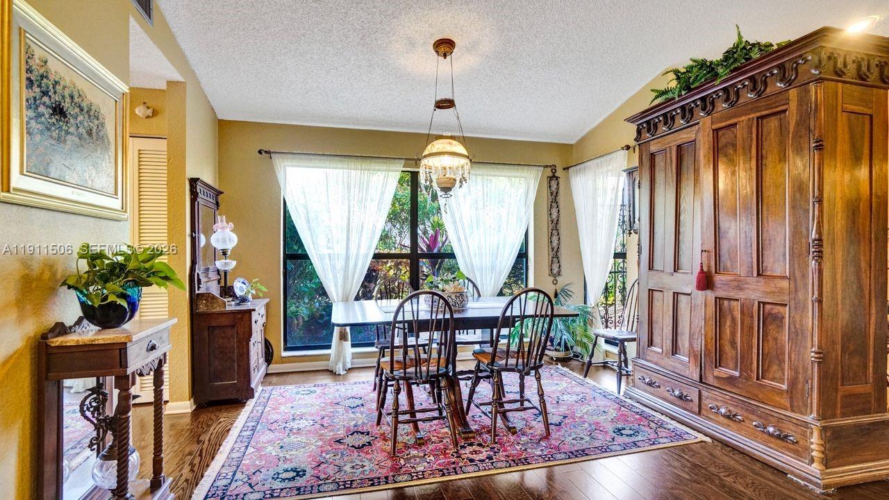 10858 White Aspen Lane Boca Raton, FL 33428 - Photo 18 of 72 a view of a dining room with furniture window and wooden floor
