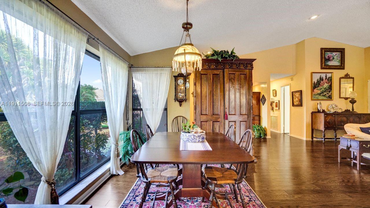 10858 White Aspen Lane Boca Raton, FL 33428 - Photo 19 of 72 a view of a dining room with furniture window and wooden floor