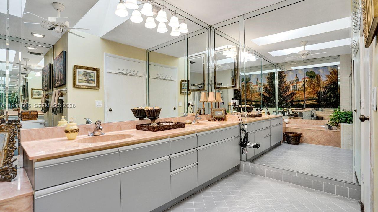 10858 White Aspen Lane Boca Raton, FL 33428 - Photo 29 of 72 a en suite bathroom with double vanity and a mirror