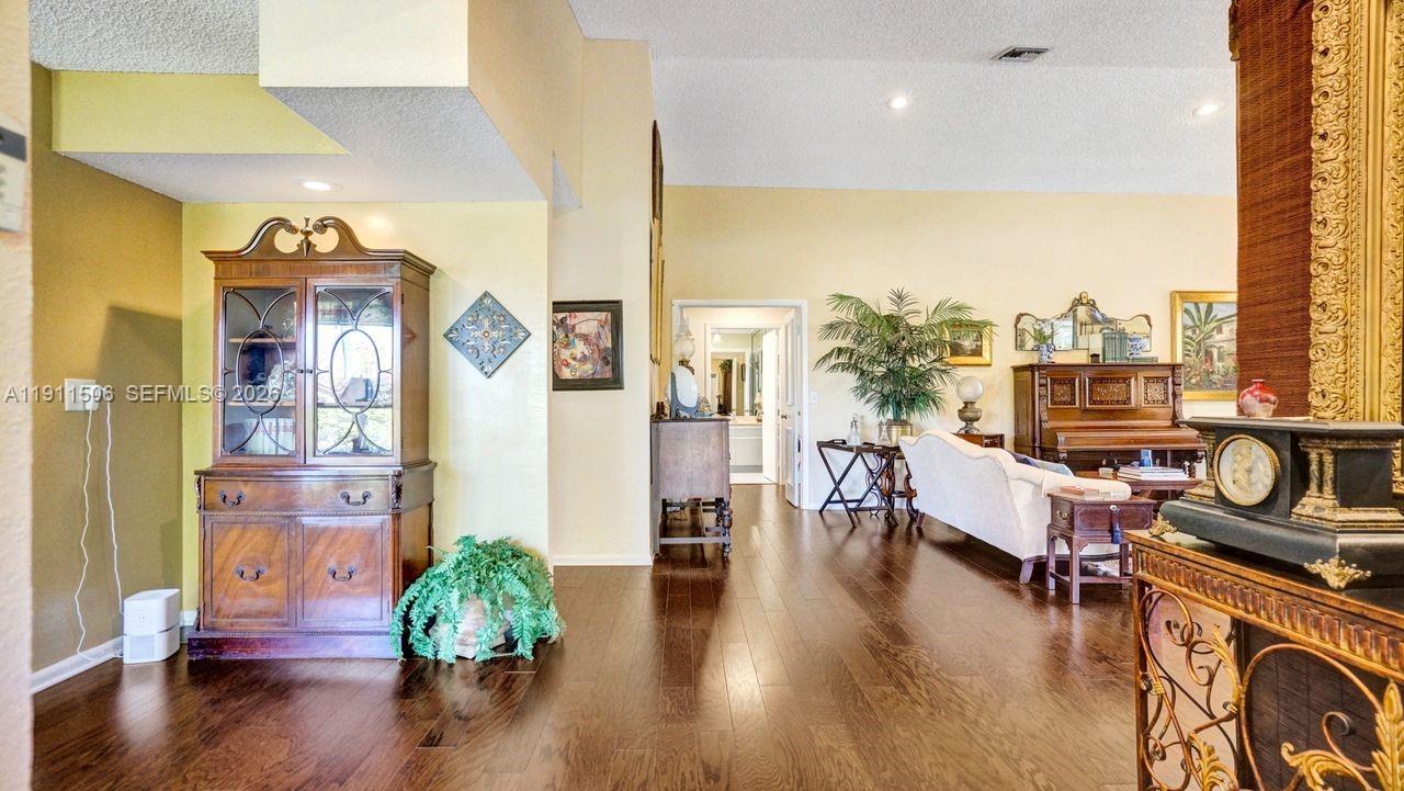 10858 White Aspen Lane Boca Raton, FL 33428 - Photo 34 of 72 a living room with furniture wooden floor and a large window