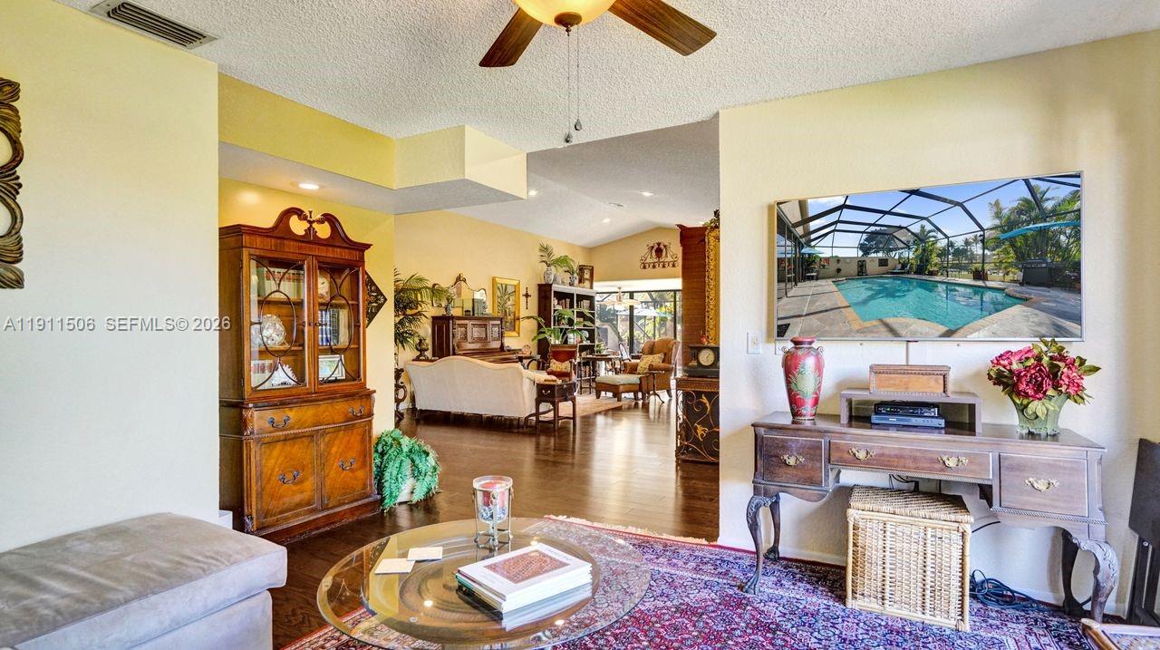 10858 White Aspen Lane Boca Raton, FL 33428 - Photo 36 of 72 a living room with lots of furniture and a painting on the wall