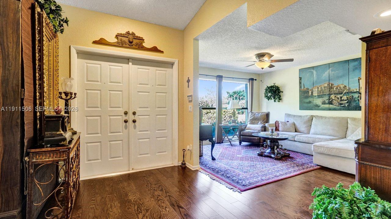 10858 White Aspen Lane Boca Raton, FL 33428 - Photo 37 of 72 a living room with furniture and wooden floor