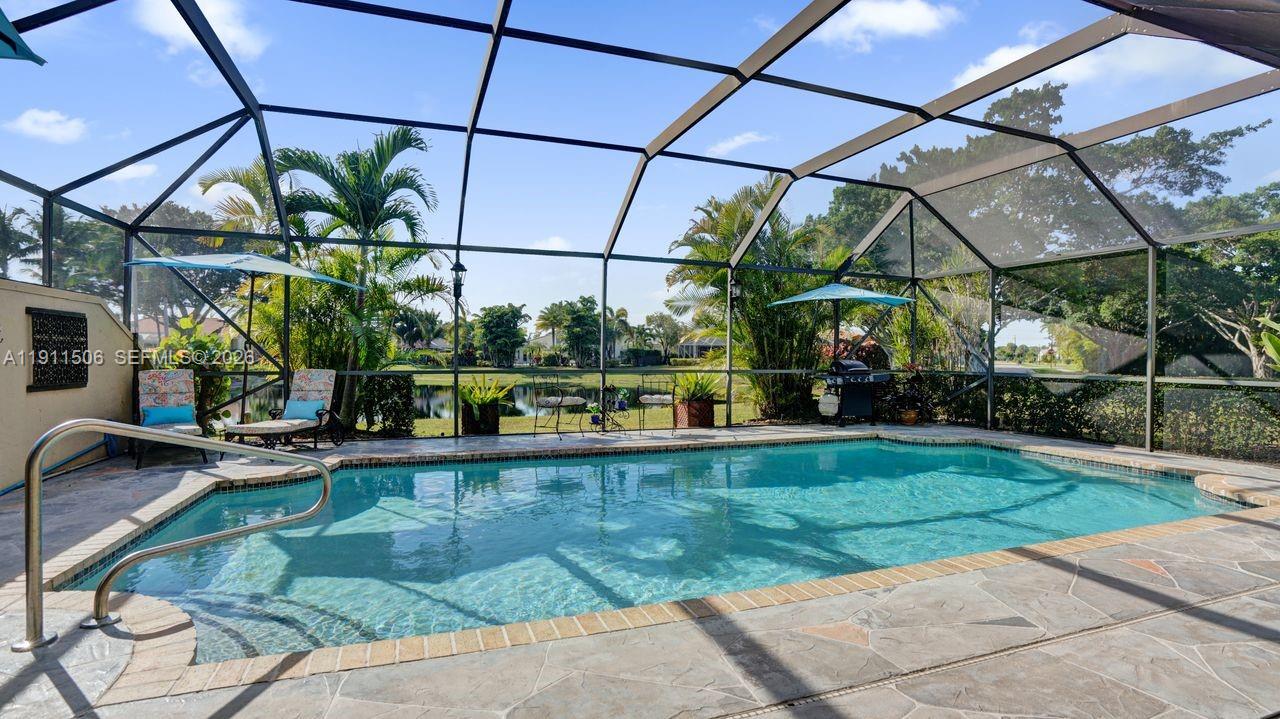 10858 White Aspen Lane Boca Raton, FL 33428 - Photo 38 of 72 a view of a swimming pool with a patio