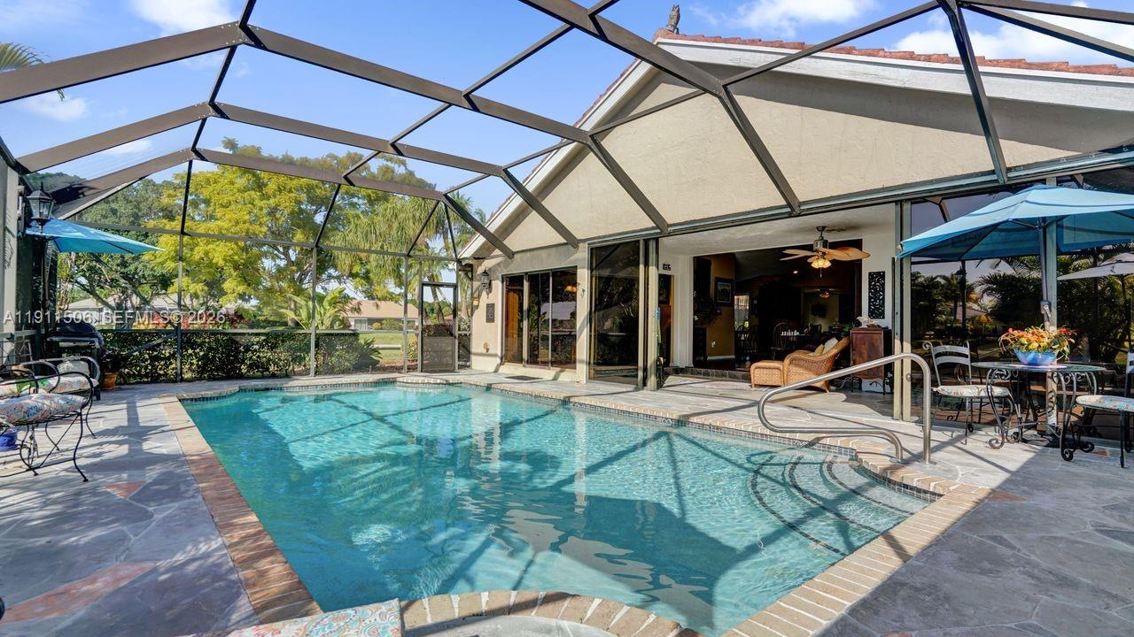10858 White Aspen Lane Boca Raton, FL 33428 - Photo 39 of 72 a view of a house with backyard sitting area and porch