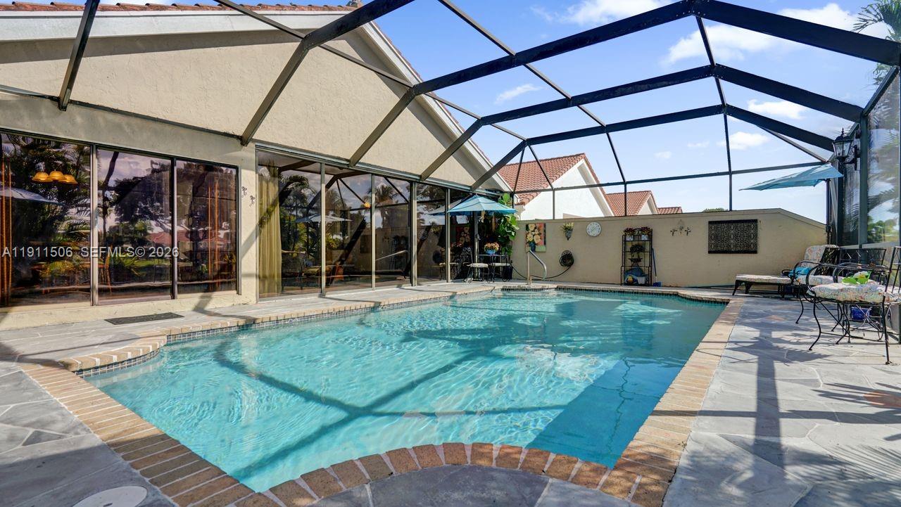 10858 White Aspen Lane Boca Raton, FL 33428 - Photo 40 of 72 a view of a backyard with sitting area