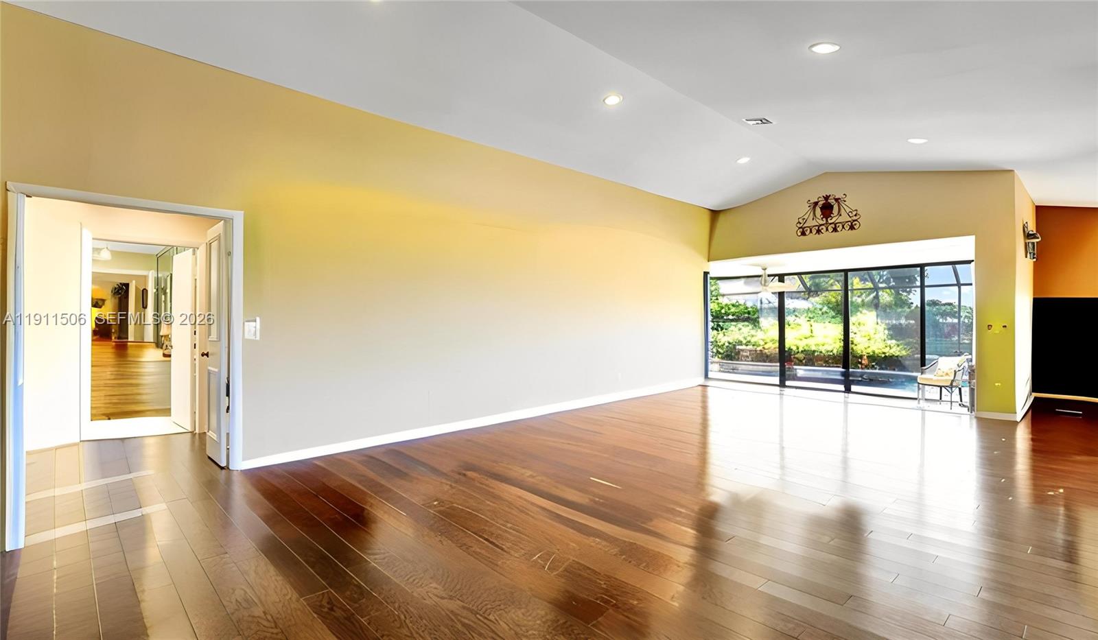 10858 White Aspen Lane Boca Raton, FL 33428 - Photo 4 of 72 a view of an empty room with wooden floor