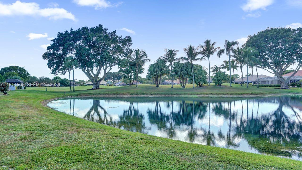 10858 White Aspen Lane Boca Raton, FL 33428 - Photo 44 of 72 a view of a lake with a building in the background