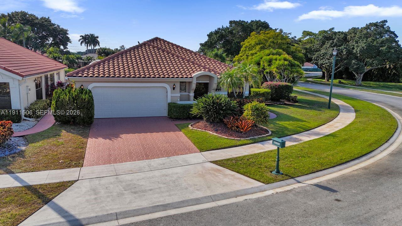 10858 White Aspen Lane Boca Raton, FL 33428 - Photo 48 of 72 a front view of a house with a yard and garage