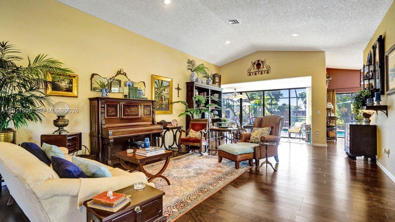 10858 White Aspen Lane Boca Raton, FL 33428 - Photo 5 of 72 a living room with furniture a fireplace and a flat screen tv