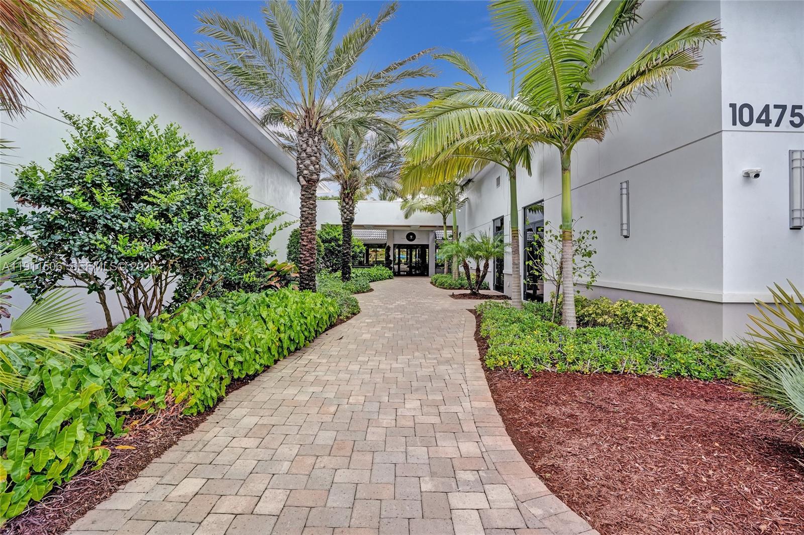 10858 White Aspen Lane Boca Raton, FL 33428 - Photo 52 of 72 a front view of a house with a garden