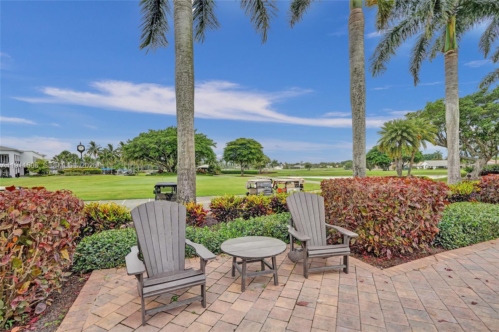 10858 White Aspen Lane Boca Raton, FL 33428 - Photo 58 of 72 a view of a patio with chairs potted plants and a palm tree