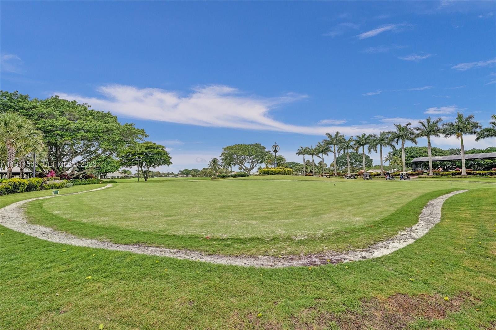 10858 White Aspen Lane Boca Raton, FL 33428 - Photo 65 of 72 a view of a field with lawn chairs and large trees