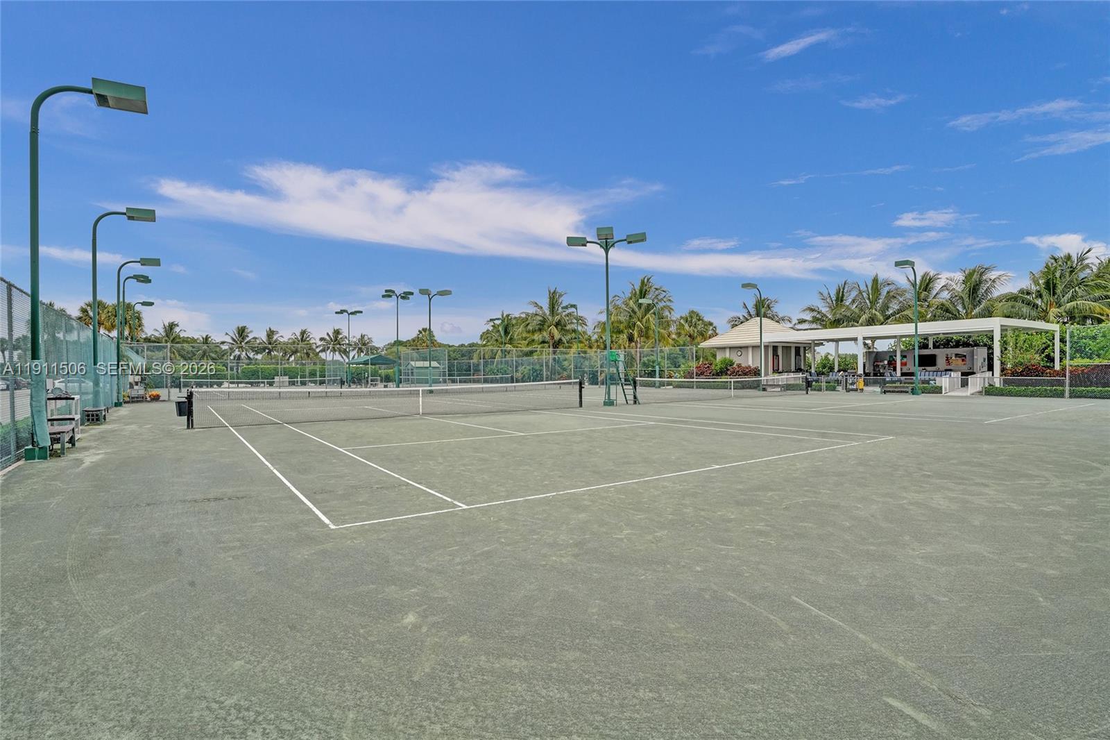 10858 White Aspen Lane Boca Raton, FL 33428 - Photo 66 of 72 a view of a tennis ground with large trees