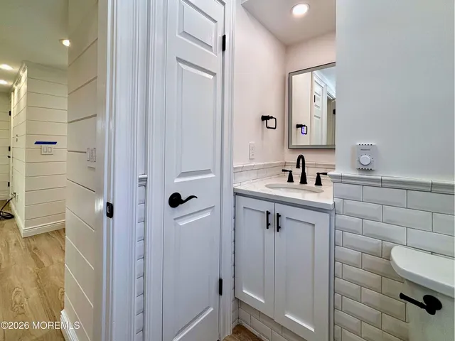 a bathroom with a shower sink and mirror