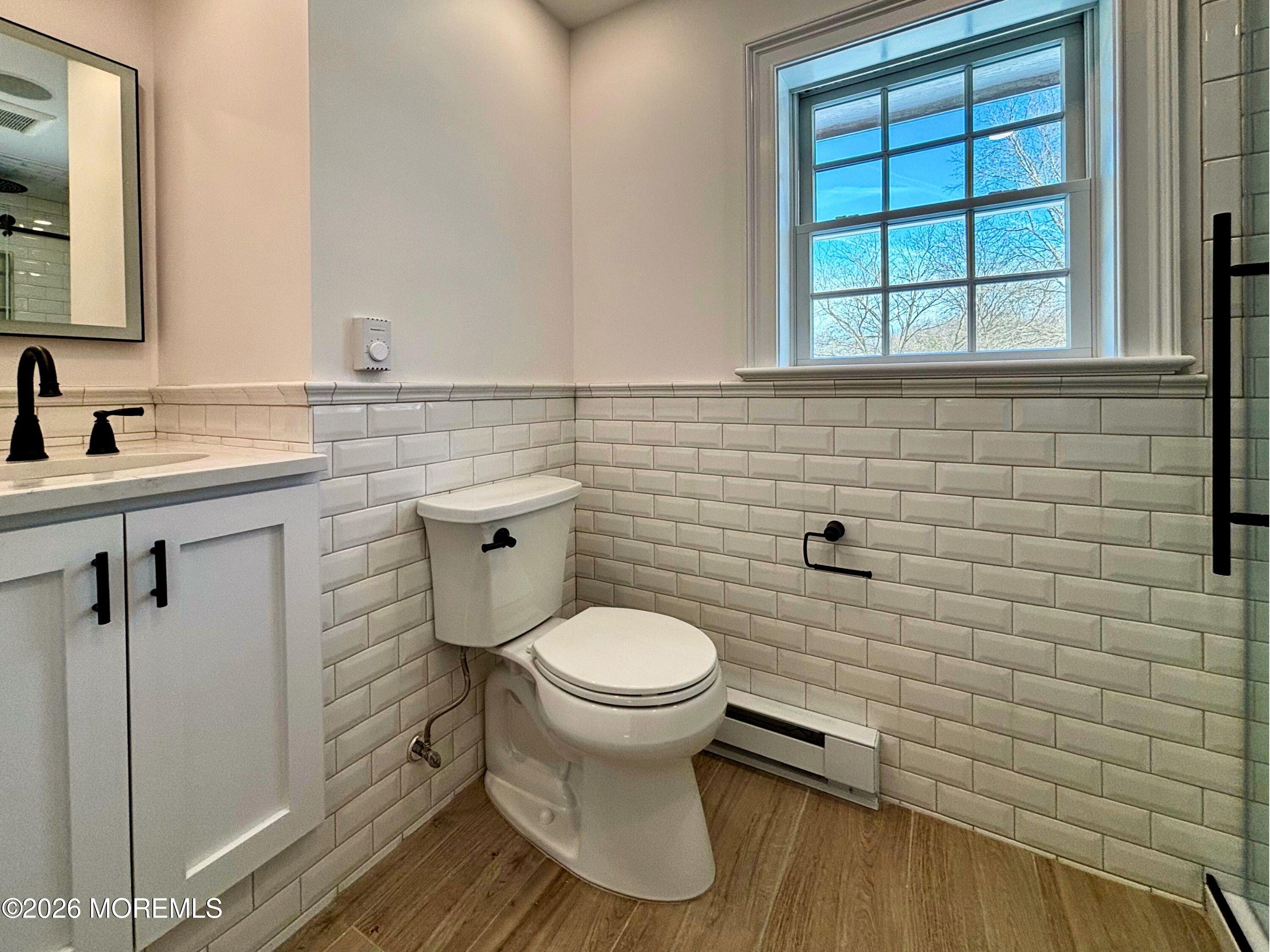 2364 Hurley Pond Road, Unit BACK TOP Wall, NJ 07719 - Photo 10 of 11 a bathroom with a toilet a sink and mirror