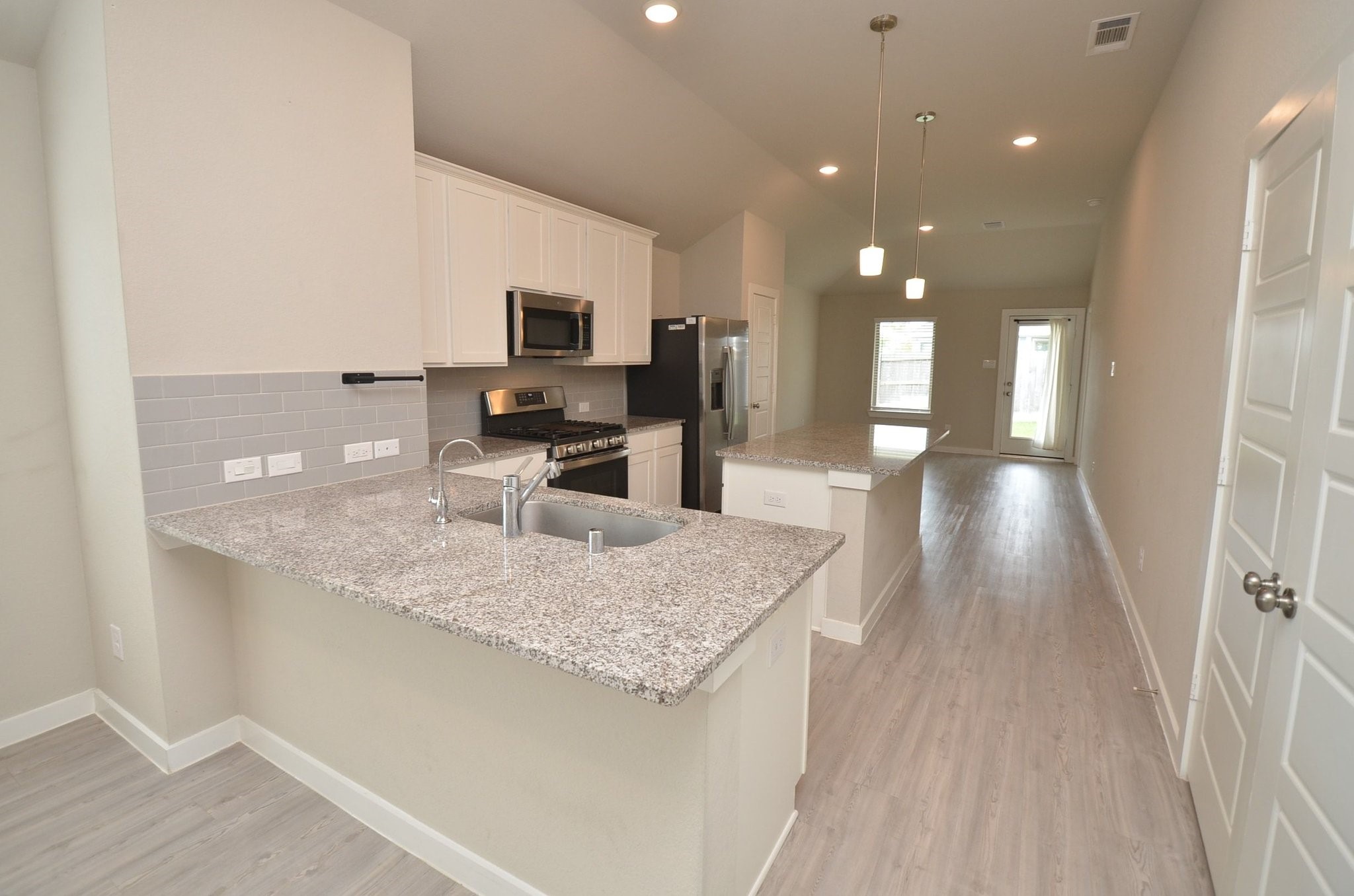 8230 Blue Fish Drive Cypress, TX 77433 - Photo 6 of 18 Spacious kitchen with Granite Countertops and white cabinets. Reverse Osmosis filtration under the kitchen sink!