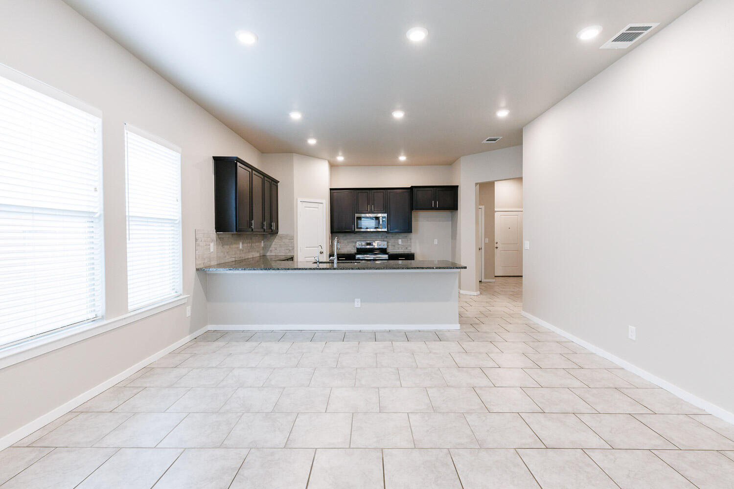 7509 26th Street Lubbock, TX 79407 - Photo 21 of 48 a view of kitchen with kitchen island granite countertop a window and a sink