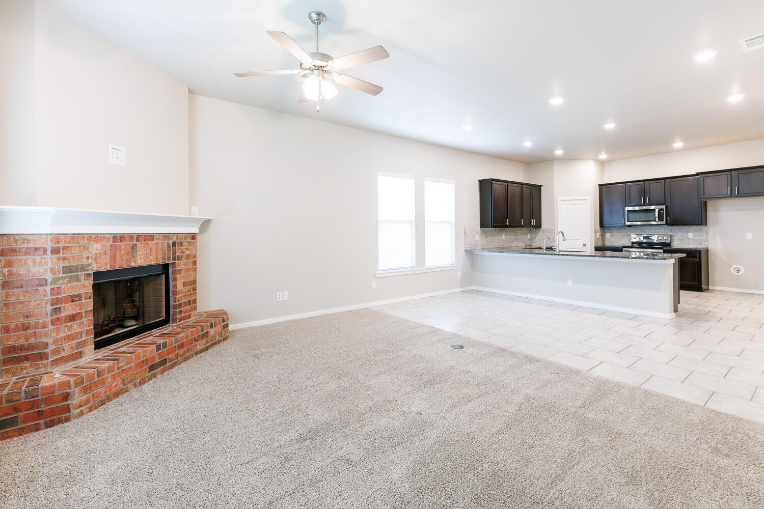 7509 26th Street Lubbock, TX 79407 - Photo 23 of 48 a view of kitchen with microwave stove top oven and cabinets