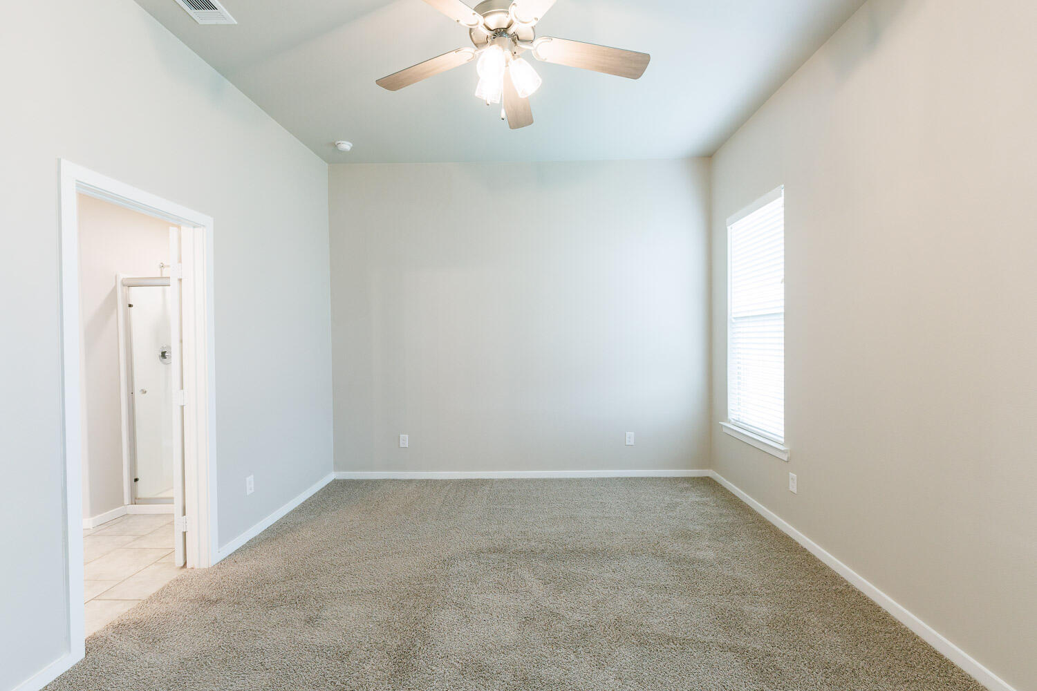 7509 26th Street Lubbock, TX 79407 - Photo 27 of 48 an empty room with windows and fan