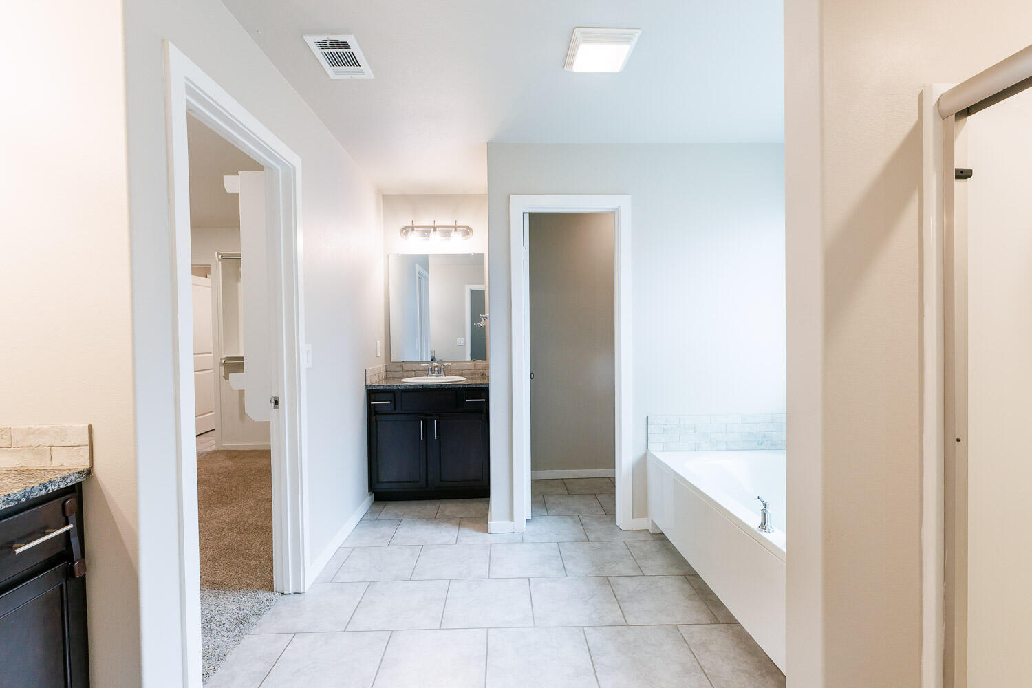 7509 26th Street Lubbock, TX 79407 - Photo 31 of 48 a bathroom with a tub shower and a sink