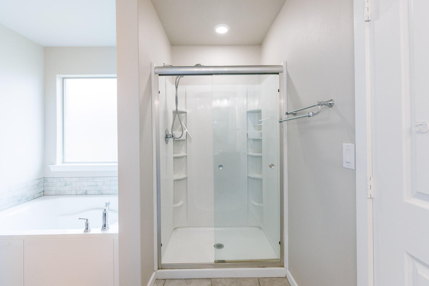 7509 26th Street Lubbock, TX 79407 - Photo 33 of 48 a bathroom with a bathtub and a shower