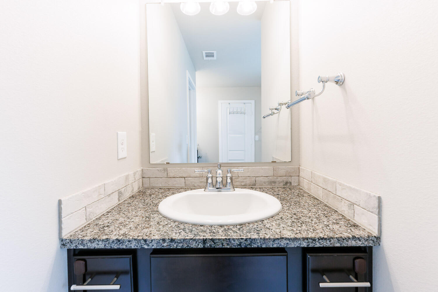 7509 26th Street Lubbock, TX 79407 - Photo 36 of 48 a bathroom with a granite countertop sink and a mirror