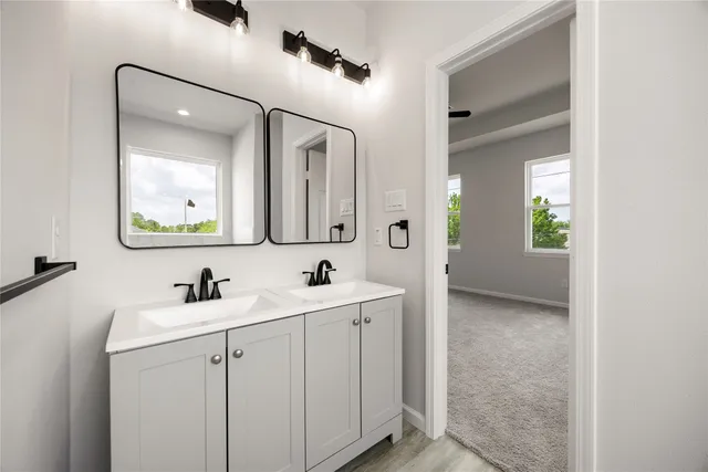 a en suite bathroom with a toilet sink and mirror